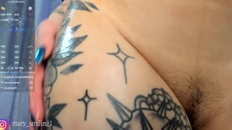 Media: Video of a tattooed arm with geometric and floral designs, including stars and a small heart, with a hand gripping the skin.