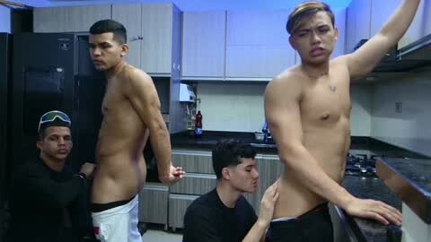Media: Video of three shirtless Asian men in a modern kitchen, one man's pants pulled down, another kissing his thigh, third man looking on.