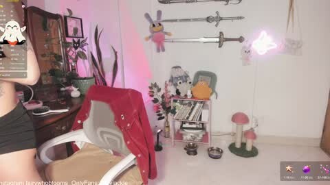 Media: Video of a cozy, whimsical bedroom with plush toys, a cat tower, a desk, and wall-mounted swords, bathed in soft pink and purple lighting.