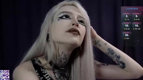 Media: Video of a pale-skinned, blonde-haired woman with dark eyeliner, tattoos, and piercings, wearing a black top, against a dark background. Text overlay shows \"LOUDHOUSE\" and streaming statistics.