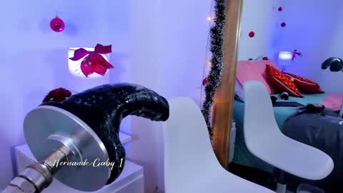 Media: Video of a sleek, black, shark-shaped lamp on a white table, with a mirror reflecting festive, red and gold decorations in a cozy, lit bedroom.
