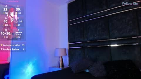 Media: Video of a dimly lit bedroom with a large, dark headboard, a TV displaying a sleep timer, and a bedside lamp.