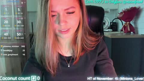 Media: A video of a blonde woman in a black top, sitting in a modern kitchen, with a live stream overlay showing her live status.