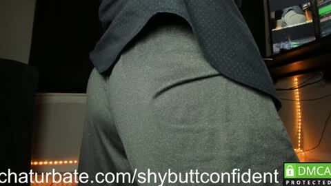Media: A video showing a person wearing grey leggings and a dark grey jacket, with the watermark \"shybuttonconfident\" and \"DMCA.com\" at the bottom.