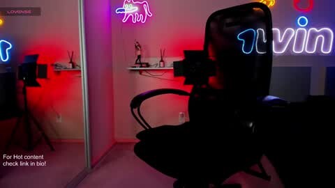 Media: Video of a dimly lit office with a black leather office chair and a neon sign reading \"Vimeo.\" Red and purple lighting creates a vibrant, modern atmosphere.