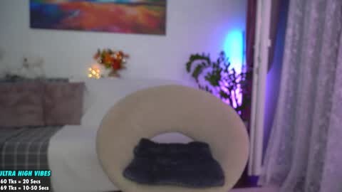 Media: A video of a modern bedroom with a beige circular chair and a colorful abstract painting on the wall. Text at the bottom reads \"Ultra High Videos 4K @ 60 fps x 1080p x 60 fps.\