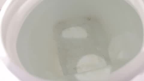 Media: Video of a white porcelain toilet bowl filled with clear water, slightly blurred, showing the water level and the curved interior of the bowl.